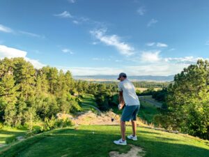 man at a tee box preparing for his golf swing
