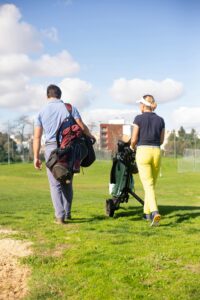 a woman using a golf push cart