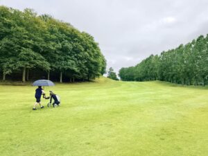 Golfer playing a round with a push cart